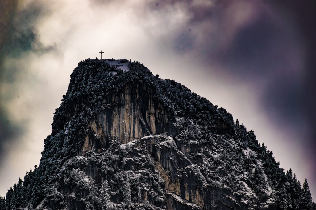 A mountain with a cross on top.