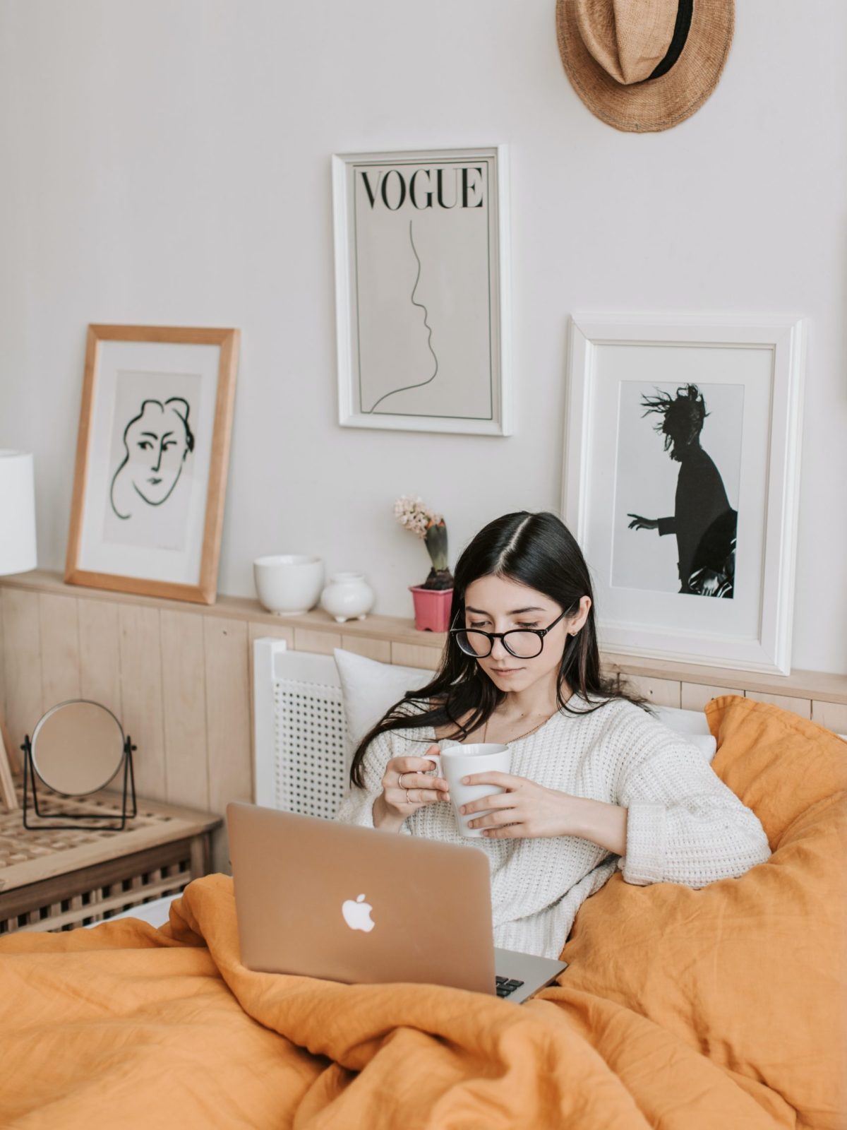 Woman reading an article while drinking coffee.